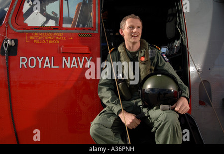 a naval surgeon pictured with a royal navy helicopter at RNAS Culdrose in Cornwall Stock Photo