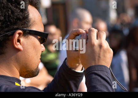 Man taking a picture with his digital camera. Stock Photo