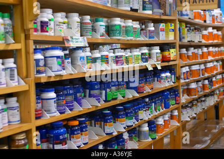 Health food and supplements shop. Vitamins and supplements lined up on store shelves.