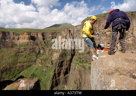 A man begins his abseil down the Maletsunyane Falls in Lesotho. Stock Photo