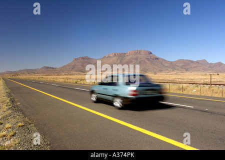 A car on the N9 highway between Graaf Reinet and Middelburg in South Africa's Eastern Cape Province. Stock Photo