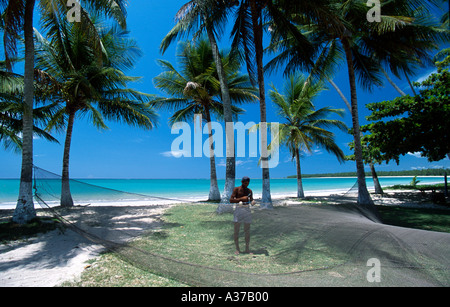 Fisherman repairing a fishnet in the beach Boipeba island Brazil Stock Photo