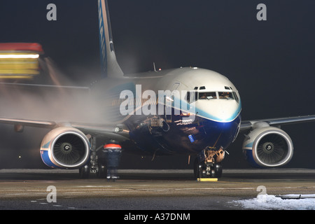 Ryanair's Boeing 737 wearing Dreamliner paint scheme during de-icing procedure in Gdansk Lech Walesa Airport. Stock Photo