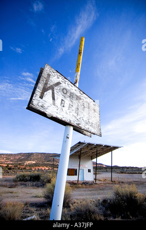 vertical wide angle shot of an abandoned gas station building in the middle of the desert Stock Photo