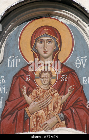 Virgin Mary and Child depicted in the ancient fresco above the gate of an orthodox church of Dormition 'at the Marketplace' in Pskov, Russia Stock Photo