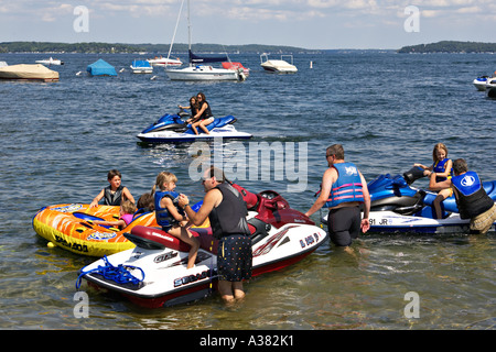 WISCONSIN Fontana Small town marina on Lake Geneva popular vacation destination boating and jetskis family together Stock Photo