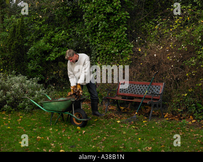 clearing leaves from autumn garden Stock Photo