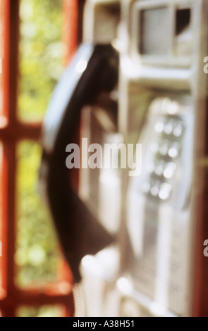 Defocussed telephone handset and keypad in a public phone kiosk or booth or box Stock Photo