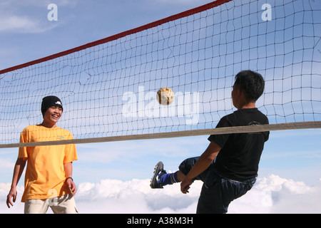 Mountain guides playing a game of takraw at Laban Rata on Mt Kinabalu, at 4095m the highest in SE Asia. Sabah, Borneo, Malaysia Stock Photo