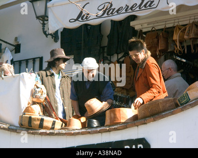 People choosing leather hats Mijas Pueblo, Andalucia, Costa del Sol, Spain Stock Photo