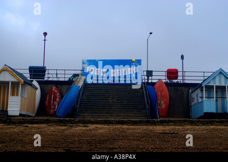 A vehicle with a large poster on the back drives along a seafront bearing the message OPEN HOUSE in the winter Stock Photo