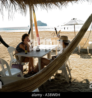 Two women sit at a table on a beach in Mazatlan Sinaloa Mexico (2007) Stock Photo