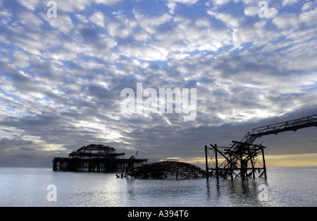 A dramatic 'Mackerel Sky' cloud formation over the silhouette of the West Pier at Brighton, destroyed in an arson attack. Stock Photo