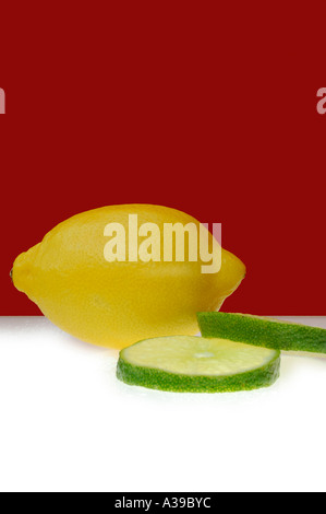 Lemon and Limes on a red and green background Stock Photo