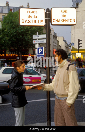 French people, young adult man, young adult woman, asking directions, Place de la Bastille, Paris, Ile-de-France, France, Europe Stock Photo