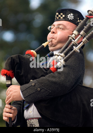 Piper in full blow on his bagpipes at Aboyne highland games, Scotland UK Stock Photo