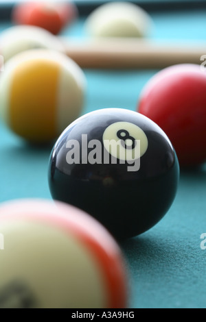 Pool table with eight ball in focus Stock Photo