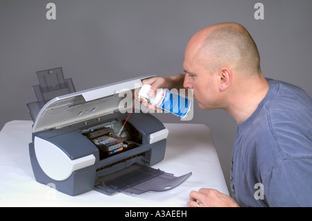 Man Cleaning Computer Printer With Compressed Air 5 Stock Photo