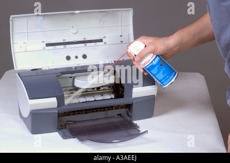 Man Cleaning Computer Printer With Compressed Air 6 Stock Photo