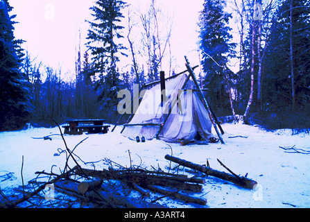 Winter Camping in Snow, Chimney Stove in Tent, Liard River Hot Springs Provincial Park, Northern British Columbia, Canada Stock Photo