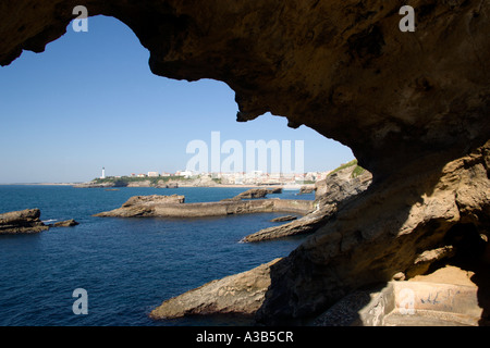 FRANCE Aquitaine Pyrenees Atlantique Biarritz Basque seaside resort on Atlantic coast and lighthouse seen through a rocky arch Stock Photo