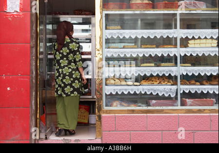 Woman Inside Cake Shop Stock Photo