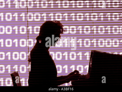 Silhouette of woman working on computer Stock Photo