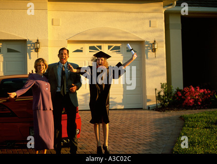 Happy highschool graduate at home with parents Stock Photo