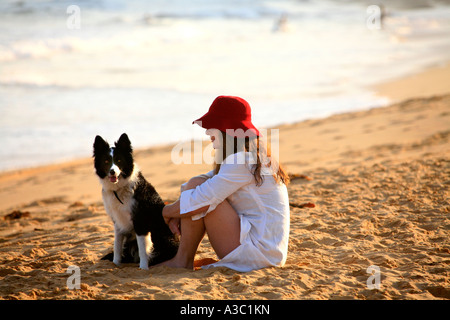 Woman and border collie on beach in Australia Stock Photo