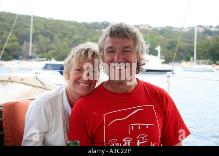 An attractive Australian middle aged couple smile together on a boat Stock Photo