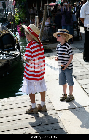 Two small children in gondola customs in the Worlds Number 1 Tourist Destination Venice Italy Stock Photo