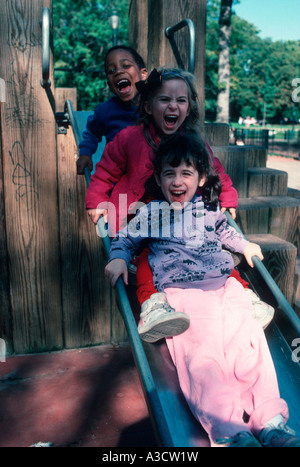 Children having fun on the slide at the playground in Brooklyn New York Stock Photo