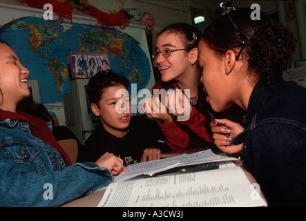 Students work together on a social studies project for presentation in class Stock Photo