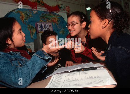 Students work together on a social studies project for presentation in class Stock Photo