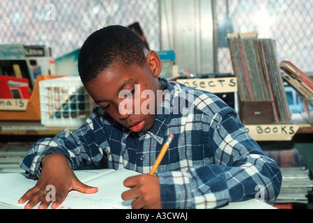 Elementary school student writing a story in class at a Brooklyn NY public school Stock Photo