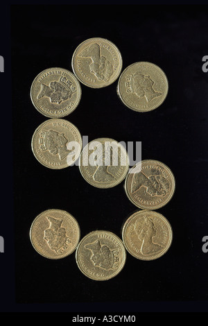 BRITISH POUND COIN FONT LETTER S ON BLACK Stock Photo