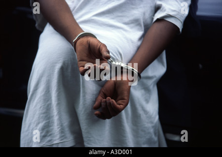 A juvenile is handcuffed while being questioned by police Kansas City MO PD Gang Squad USA Stock Photo