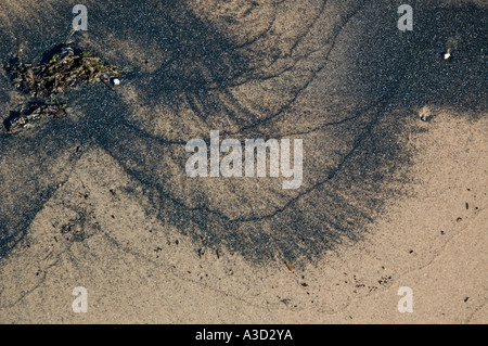 Black pattern formed on beach by water waves Stock Photo - Alamy