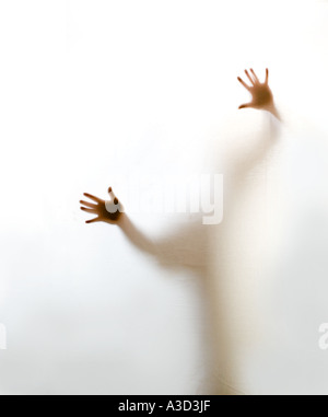 Hands trying to reach through a barrier Stock Photo