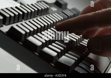 Pressing keys on computer keyboard Stock Photo