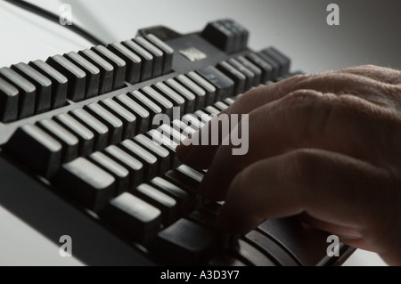 Pressing keys on computer keyboard Stock Photo