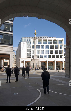 People in redeveloped Paternoster Square with Corinthian column relocated offices of London Stock Exchange framed by Temple Bar arch City of London UK Stock Photo