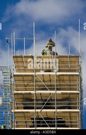 Close up top of Lord Nelsons column & scaffolding as workers carry out maintenance repairs & cleaning from scaffold tower Trafalgar Square London UK Stock Photo