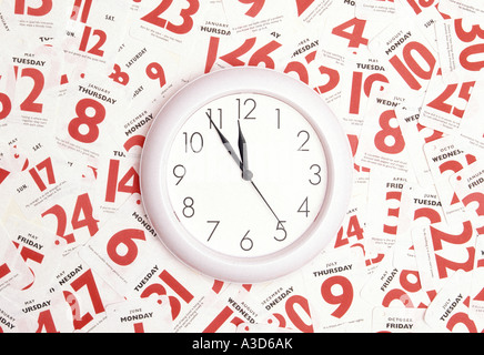 Time date calendar appointment conceptual image using clock face & red dates of week month & year as concept for people who try to manage a busy life Stock Photo