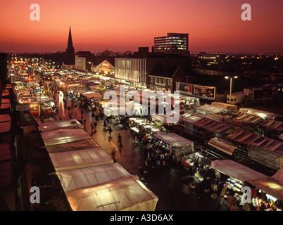 Historical 1990s archive aerial birds eye winter sunset view looking down on urban landscape stalls & shoppers in Romford market place East London UK Stock Photo