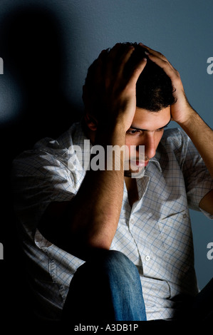 Close up of a depressed man indoors Stock Photo