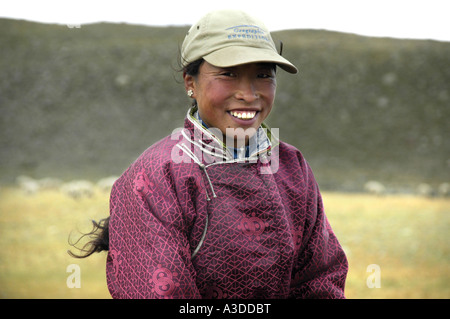 Portrait nomads smiling young woman dressed in traditional coat in the steppe Kharkhiraa Mongolian Altai near Ulaangom Uvs Aymag Stock Photo