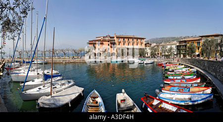 Harbour with sailing ships and small fishing boats, Torri del Benaco, Garda lake, Italy Stock Photo