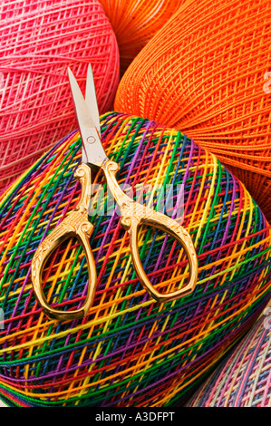 Scissors cutting a pink string Stock Photo - Alamy