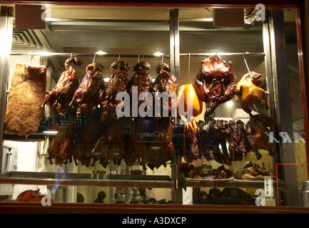 Cooked Peking ducks hanging in a chinese takeaway restaurant Chinatown London Stock Photo